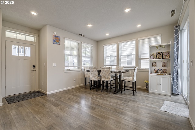 30942 NW Turel Dr, North Plains, OR 97133 - dining room featuring baseboards, plenty of natural light, light wood-type flooring, recessed lighting, and a textured ceiling
