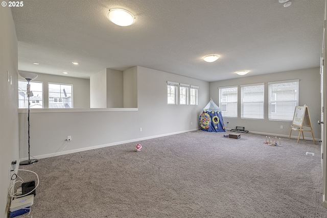 30942 NW Turel Dr, North Plains, OR 97133 - recreation room with baseboards, a textured ceiling, and carpet