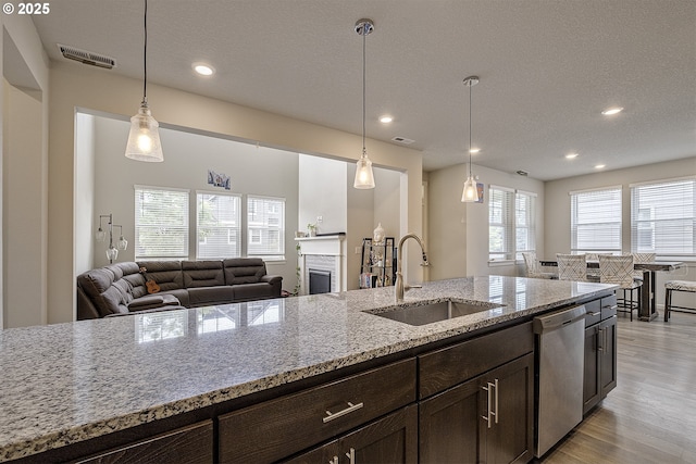30942 NW Turel Dr, North Plains, OR 97133 - kitchen featuring dishwasher, a sink, light wood-style floors, dark brown cabinetry, and recessed lighting