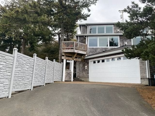 view of front of property with driveway and fence