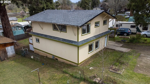 view of side of home with roof with shingles and a chimney