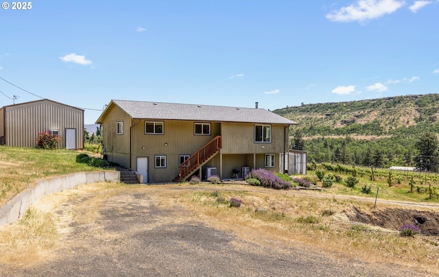 5073 Chenoweth Rd, The Dalles, OR 97058 - rear view of property with stairway, cooling unit, and dirt driveway