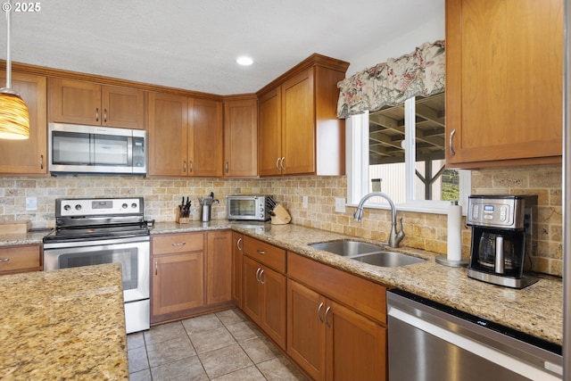 5073 Chenoweth Rd, The Dalles, OR 97058 - kitchen with stainless steel appliances, a sink, brown cabinetry, backsplash, and recessed lighting