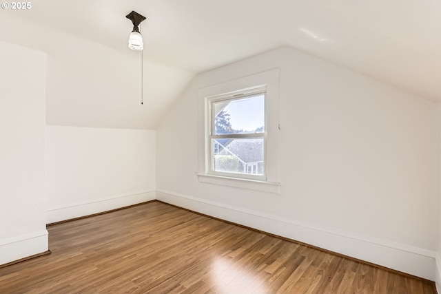 bonus room featuring hardwood / wood-style flooring and lofted ceiling