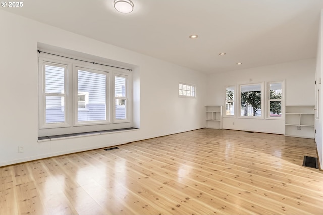 unfurnished living room with light hardwood / wood-style flooring