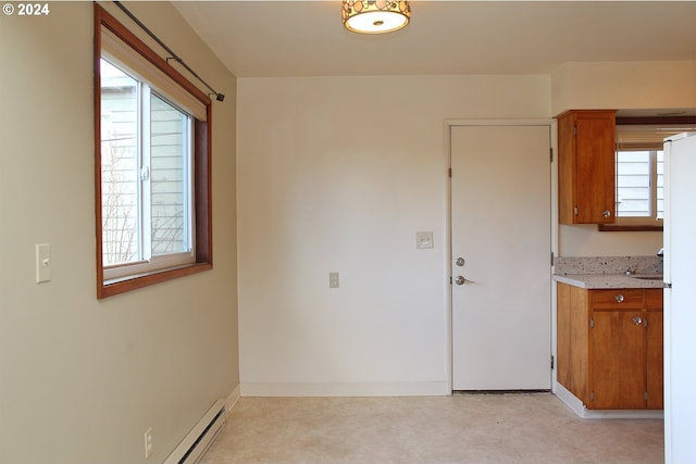 empty room with a baseboard radiator and baseboards