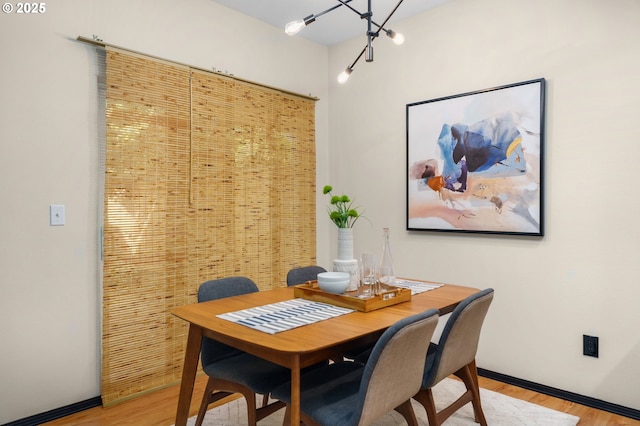 dining room with light wood-style flooring and baseboards