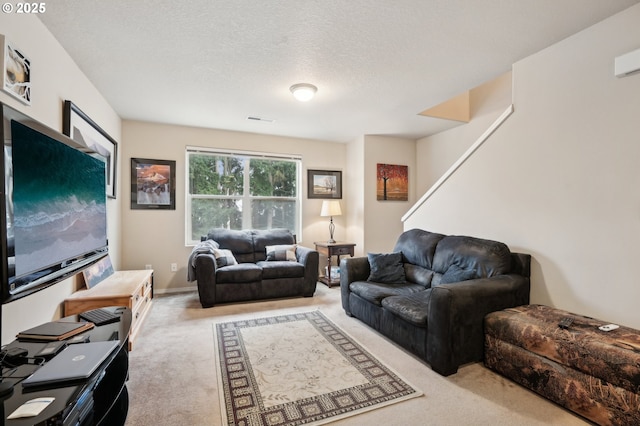 carpeted living room with a textured ceiling