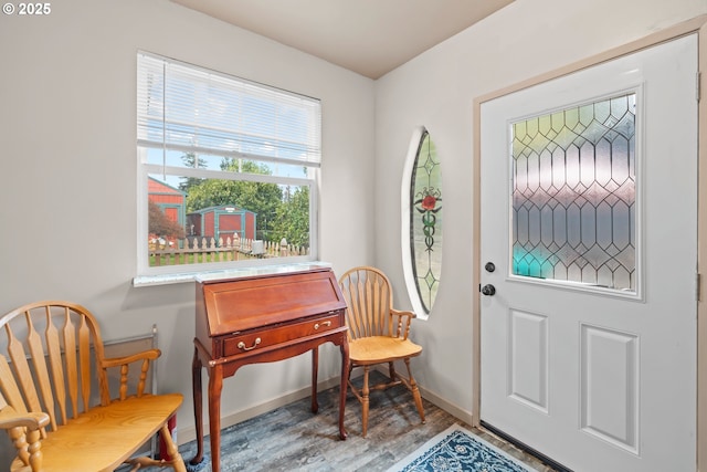 entryway with baseboards and wood finished floors