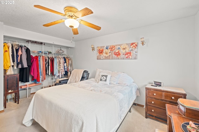 carpeted bedroom featuring baseboards, a closet, and a ceiling fan
