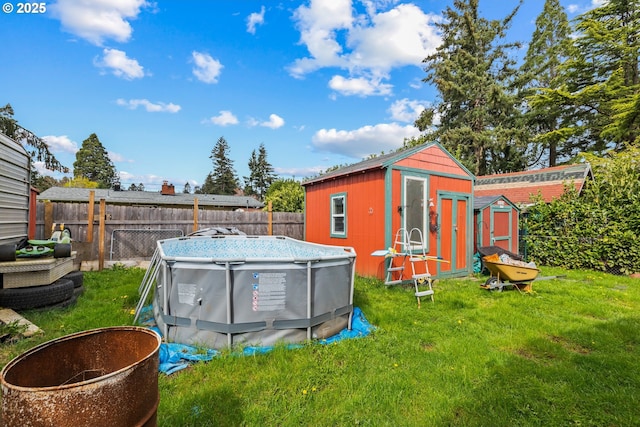 view of shed with a fenced in pool and a fenced backyard