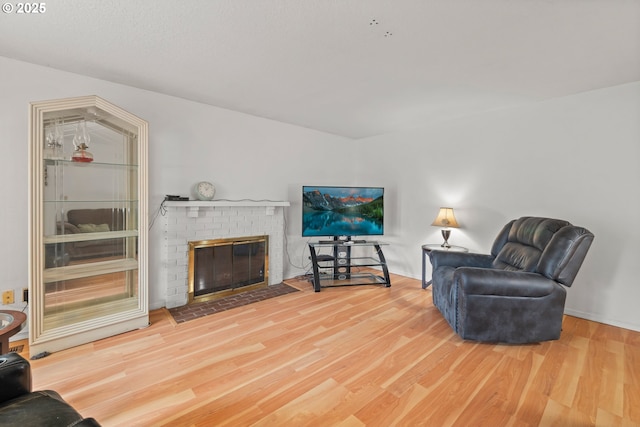 living area featuring a fireplace and wood finished floors