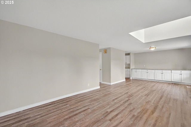 110 Wilshire Way, Kelso, WA 98626 - spare room featuring light wood-style floors, baseboards, and a skylight