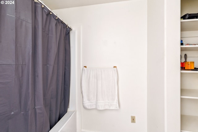 bathroom with shower / bath combination with curtain