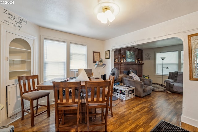 dining room featuring dark wood-type flooring and baseboard heating