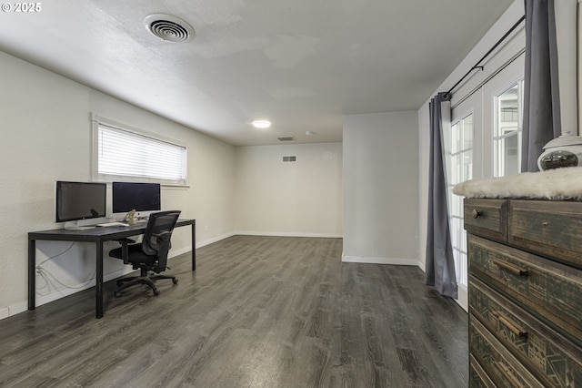home office featuring dark wood-type flooring, visible vents, and baseboards