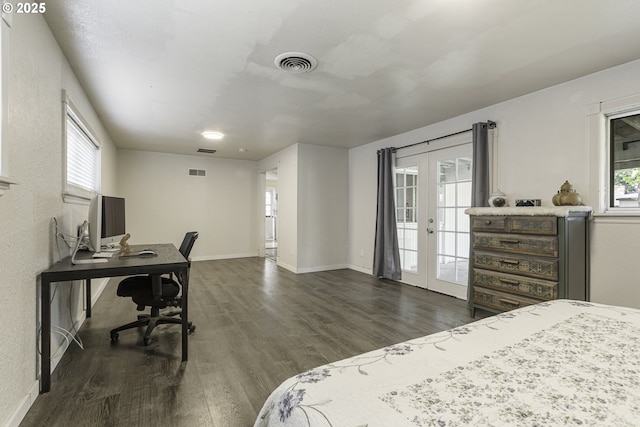 bedroom with dark wood-type flooring, visible vents, access to outside, and french doors