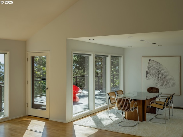 3342 SW Fairmount Blvd, Portland, OR 97239 - dining area with wood finished floors, baseboards, and high vaulted ceiling