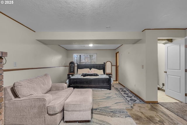 bedroom with a textured ceiling and baseboards