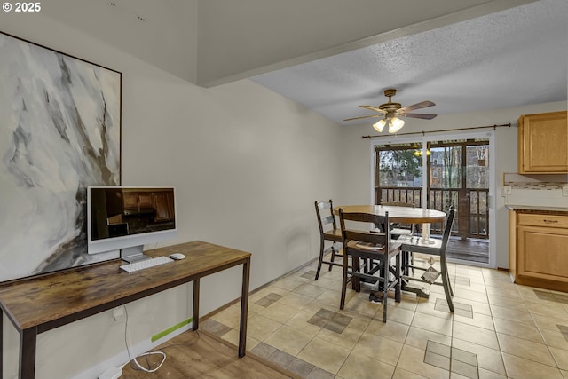 dining area with ceiling fan, a textured ceiling, and light tile patterned flooring