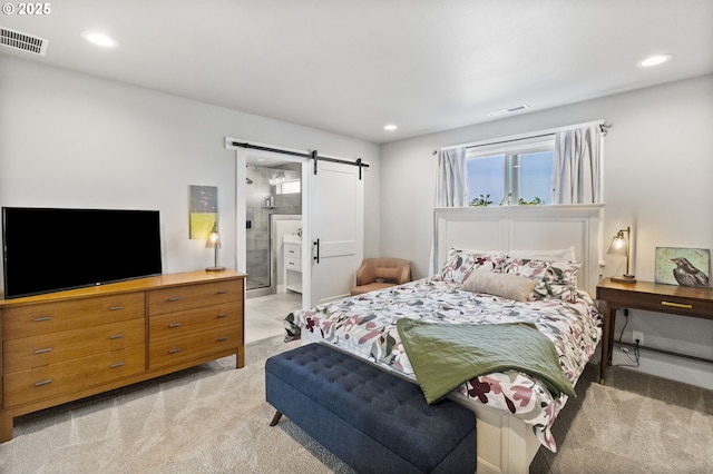 3588 Nestucca Loop, Eugene, OR 97408 - bedroom with a barn door, light colored carpet, recessed lighting, and ensuite bathroom