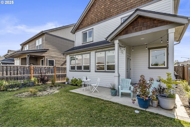 3588 Nestucca Loop, Eugene, OR 97408 - back of property featuring a fenced backyard, a patio, and roof with shingles