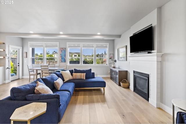 3588 Nestucca Loop, Eugene, OR 97408 - living room featuring light wood finished floors, recessed lighting, a glass covered fireplace, and plenty of natural light
