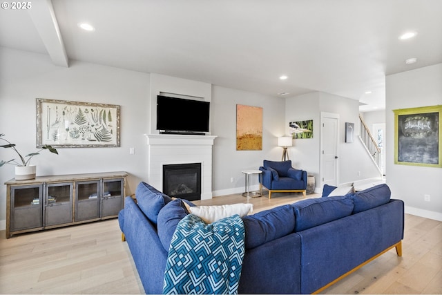 3588 Nestucca Loop, Eugene, OR 97408 - living area with wood finished floors, stairway, recessed lighting, and a glass covered fireplace