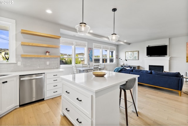 3588 Nestucca Loop, Eugene, OR 97408 - kitchen with dishwasher, open floor plan, a breakfast bar, recessed lighting, and light wood-type flooring