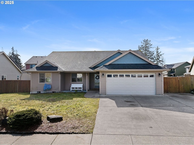 view of front of property with a garage, concrete driveway, a front yard, and fence