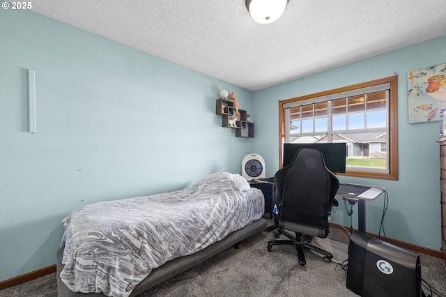 bedroom with carpet floors, a textured ceiling, and baseboards