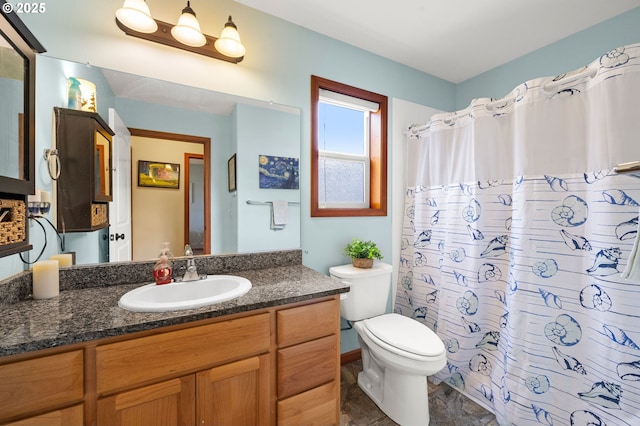 full bathroom with a shower with curtain, vanity, and toilet