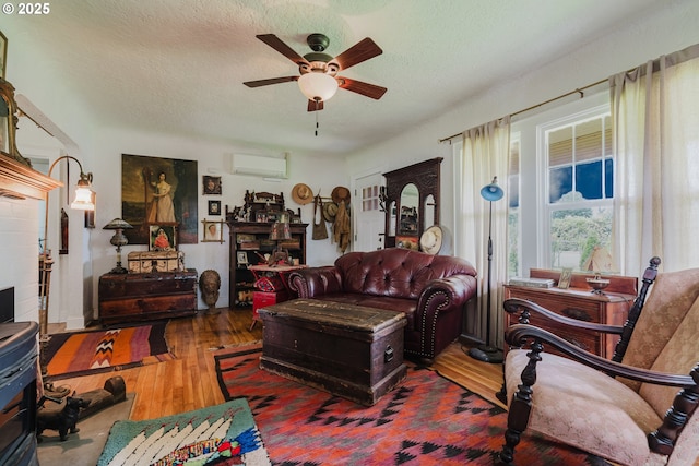 2112 Salem Ave, Albany, OR 97321 - living area with an AC wall unit, a ceiling fan, wood finished floors, and a textured ceiling