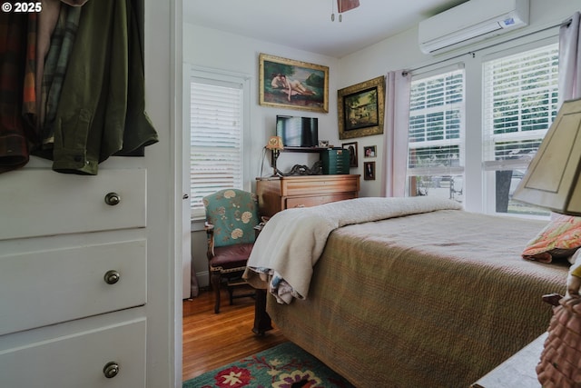 2112 Salem Ave, Albany, OR 97321 - bedroom featuring a wall unit AC, wood finished floors, and ceiling fan