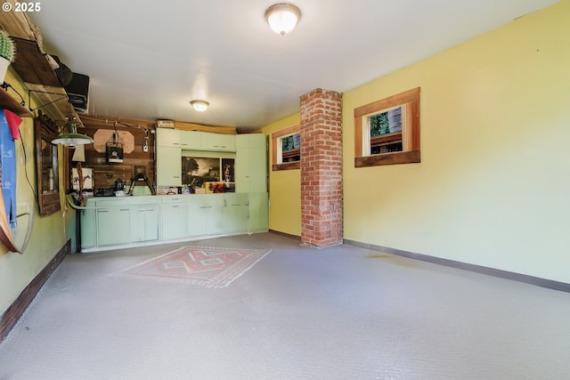 2112 Salem Ave, Albany, OR 97321 - unfurnished living room featuring baseboards, ornate columns, and carpet flooring