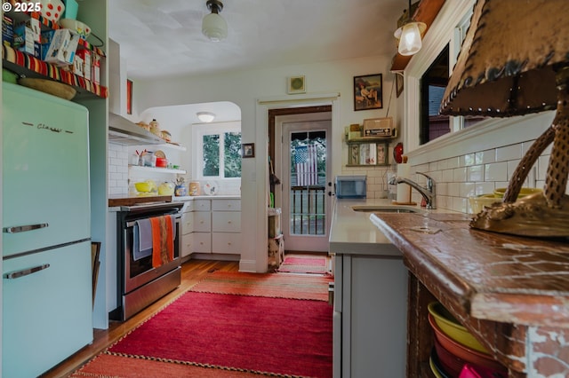 2112 Salem Ave, Albany, OR 97321 - kitchen with freestanding refrigerator, stainless steel electric stove, a sink, and decorative backsplash