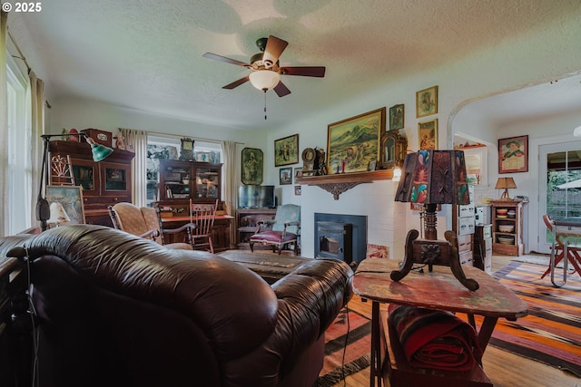 2112 Salem Ave, Albany, OR 97321 - living area with a ceiling fan, a textured ceiling, a fireplace, and wood finished floors