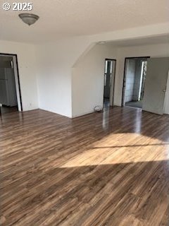 spare room with dark wood-style flooring