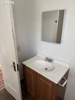 bathroom with wood finished floors and vanity