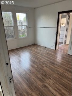 unfurnished room with dark wood-style floors