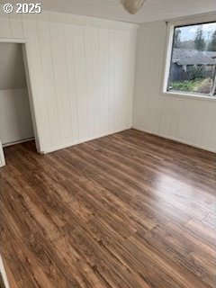 unfurnished bedroom with dark wood-style floors