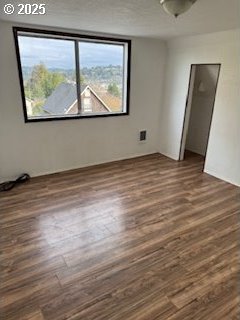 empty room with dark wood finished floors