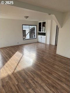 unfurnished living room with dark wood-style floors