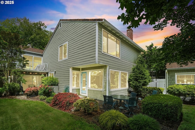570 N Hayden Bay Dr, Portland, OR 97217 - property exterior at dusk featuring a chimney