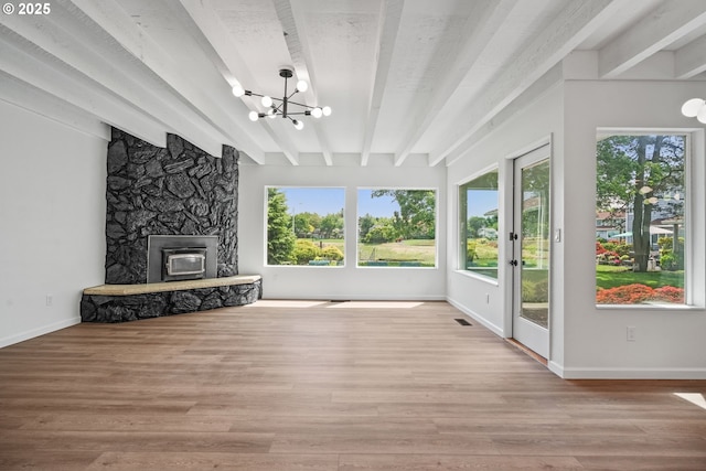 570 N Hayden Bay Dr, Portland, OR 97217 - unfurnished living room with beamed ceiling, healthy amount of natural light, a chandelier, wood finished floors, and baseboards