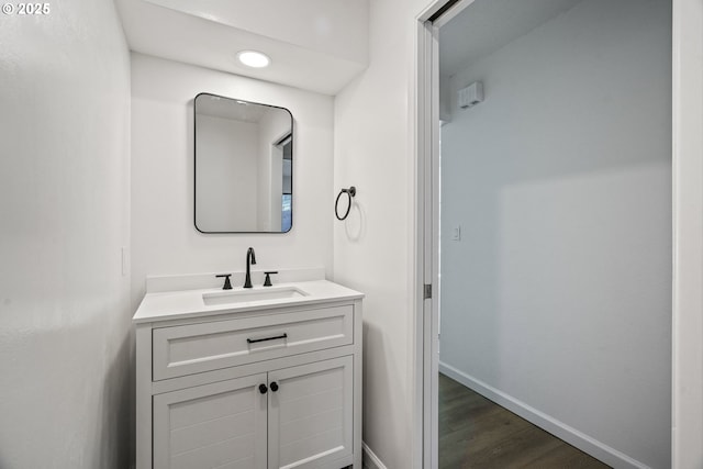 570 N Hayden Bay Dr, Portland, OR 97217 - bathroom featuring vanity, wood finished floors, baseboards, and recessed lighting