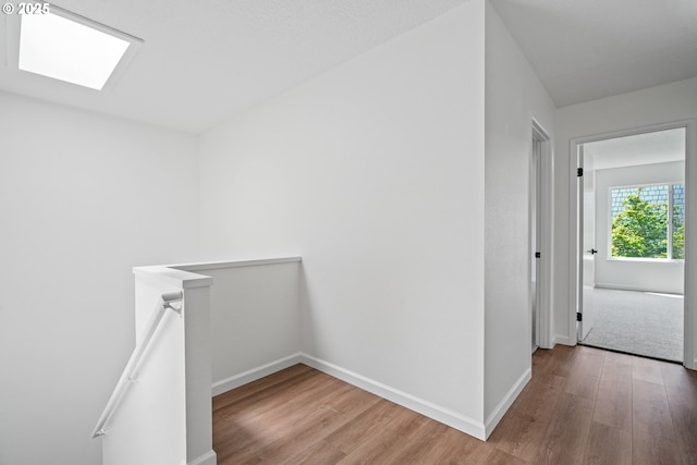 570 N Hayden Bay Dr, Portland, OR 97217 - hall featuring wood finished floors, an upstairs landing, baseboards, and a skylight