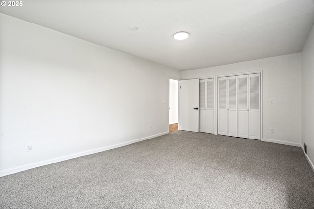 570 N Hayden Bay Dr, Portland, OR 97217 - unfurnished bedroom with multiple closets, baseboards, and carpet floors