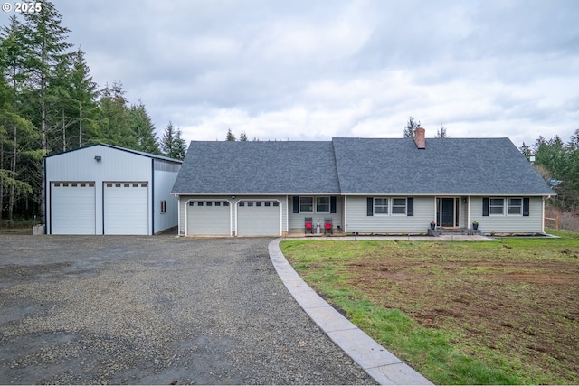 ranch-style house featuring driveway, a shingled roof, and a front lawn