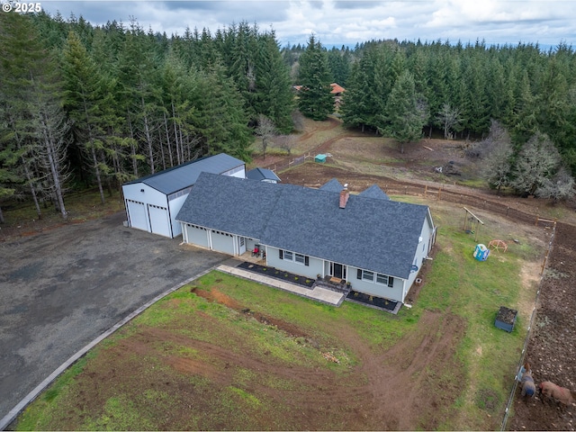 birds eye view of property featuring a view of trees